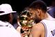 SAN ANTONIO, TX - JUNE 15: Tim Duncan #21 of the San Antonio Spurs holds the Larry O'Brien trophy on the court after defeating the Miami Heat in Game Five of the 2014 NBA Finals at the AT&T Center on June 15, 2014 in San Antonio, Texas. NOTE TO USER: User expressly acknowledges and agrees that, by downloading and or using this photograph, User is consenting to the terms and conditions of the Getty Images License Agreement. (Photo by Andy Lyons/Getty Images)