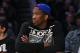 Kansas center Joel Embiid watches the Los Angeles Lakers play the Memphis Grizzlies in an NBA basketball game, Sunday, April 13, 2014, in Los Angeles. The Grizzlies won 102-90. (AP Photo/Mark J. Terrill)