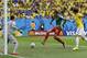 Cameroon's Joel Matip, center, scores his side's first goal during the group A World Cup soccer match between Cameroon and Brazil at the Estadio Nacional in Brasilia, Brazil, Monday, June 23, 2014. (AP Photo/Dolores Ochoa)
