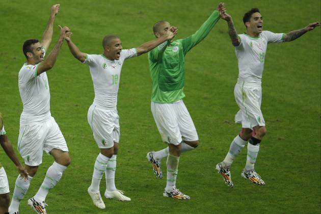 Members of the Algerian soccer team join hands as they celebrate after winning 4-2, the group H World Cup soccer match between South Korea and Algeria at the Estadio Beira-Rio in Porto Alegre, Brazil, Sunday, June 22, 2014. (AP Photo/Michael Sohn)