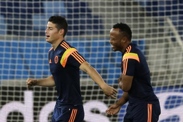 Colombia's James Rodriguez, left, and Juan Zuniga warm up during a training session of Colombia at Arena Pantanal in Cuiaba, Brazil, Monday, June 23, 2014. Colombia play in group C of the 2014 soccer World Cup. (AP Photo/Shuji Kajiyama)