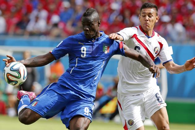 Italy's Mario Balotelli, left, gets in a shot despite the challenge of Costa Rica's Oscar Duarte during the group D World Cup soccer match between Italy and Costa Rica at the Arena Pernambuco in Recife, Brazil, Friday, June 20, 2014. (AP Photo/Frank Augstein)