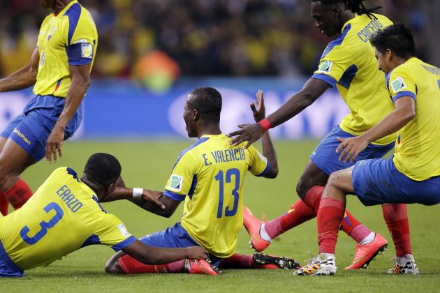 Ecuador's Enner Valencia, center, celebrates with teammates after scoring his team's second goal during the group E World Cup soccer match between Honduras and Ecuador at the Arena da Baixada in Curitiba, Brazil, Friday, June 20, 2014. (AP Photo/Michael Sohn)
