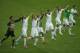 Members of the Algerian soccer team join hands as they celebrate on the pitch after winning 4-2 , the group H World Cup soccer match between South Korea and Algeria at the Estadio Beira-Rio in Porto Alegre, Brazil, Sunday, June 22, 2014. (AP Photo/Michael Sohn)