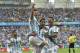 Argentina's Lionel Messi, left, is carried by his teammates Argentina's Angel di Maria (7) and Argentina's Marcos Rojo after scoring his side's first goal during the group F World Cup soccer match between Nigeria and Argentina at the Estadio Beira-Rio in Porto Alegre, Brazil, Wednesday, June 25, 2014. (AP Photo/Martin Meissner)