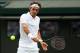 LONDON, ENGLAND - JUNE 24: Roger Federer of Switzerland plays a backhand during his Gentlemen's Singles first round match against Paolo Lorenzi of Italy on day two of the Wimbledon Lawn Tennis Championships at the All England Lawn Tennis and Croquet Club at Wimbledon on June 24, 2014 in London, England. (Photo by Jan Kruger/Getty Images)