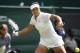 Li Na of China plays a return to Paula Kania of Poland during their first round match at the All England Lawn Tennis Championships in Wimbledon, London, Monday, June 23, 2014. (AP Photo/Pavel Golovkin)