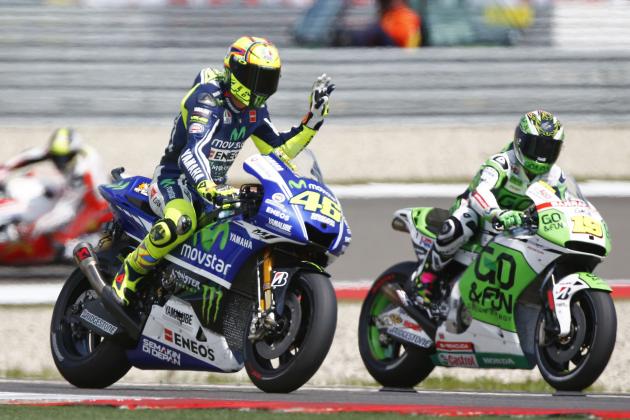 Valentino Rossi of Italy, left, gestures on his Yamaha during the second MotoGP Free Practice of the Dutch Grand Prix, in Assen, northern Netherlands, Thursday June 26,2014. (AP Photo/Vincent Jannink)