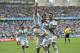 Argentina's Lionel Messi, left, is carried by his teammates Argentina's Angel di Maria (7) and Argentina's Marcos Rojo after scoring his side's first goal during the group F World Cup soccer match between Nigeria and Argentina at the Estadio Beira-Rio in Porto Alegre, Brazil, Wednesday, June 25, 2014. (AP Photo/Martin Meissner)
