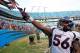 Denver Broncos' Nate Irving (56) shares some gloves with some fans after the Broncos beat the Carolina Panthers 36-14 in an NFL football game in Charlotte, N.C., Sunday, Nov. 11, 2012. (AP Photo/Bob Leverone)