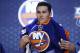 Michael Dal Colle pulls on a New York Islanders sweater after being chosen fifth overall during the first round of the NHL hockey draft, Friday, June 27, 2014, in Philadelphia. (AP Photo/Matt Slocum)