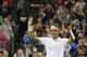 CAPTION CORRECTS THE PHOTOGRAPHER BYLINE FROM BEN CURTIS TO GOLOVKIN Roger Federer of Switzerland celebrates after defeating Gilles Muller of Luxembourg in their men's singles match at the All England Lawn Tennis Championships in Wimbledon, London, Thursday, June 26, 2014. (AP Photo/Pavel Golovkin)