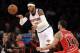 New York Knicks' Carmelo Anthony, left, passes the ball past Chicago Bulls' D.J. Augustin during the first half of the NBA basketball game, Sunday, April 13, 2014 in New York. The Knicks defeated the Bulls 100-89. (AP Photo/Seth Wenig)