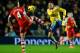 SOUTHAMPTON, ENGLAND - JANUARY 28: Morgan Schneiderlin of Southampton and Mesut Oezil of Arsenal compete for the ball during the Barclays Premier League match between Southampton and Arsenal at St Mary's Stadium on January 28, 2014 in Southampton, England. (Photo by Mike Hewitt/Getty Images)