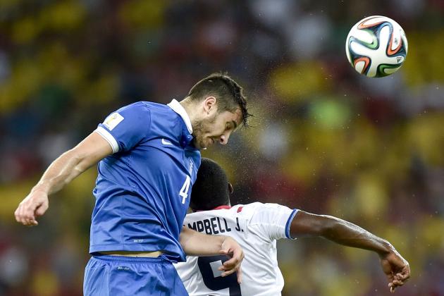 Greece's Kostas Manolas heads the ball over Costa Rica's Joel Campbell during the World Cup round of 16 soccer match between Costa Rica and Greece at the Arena Pernambuco in Recife, Brazil, Sunday, June 29, 2014. (AP Photo/Martin Meissner)