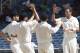 New Zealand's bowler Tim Southee, right, is congratulated by teammates after taking the wicket of West Indies batsman Kieran Powell, who was caught behind for a duck during the second innings on the fourth day of their first cricket Test match in Kingston, Jamaica, Wednesday, June 11, 2014. (AP Photo/Arnulfo Franco)