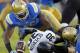 UCLA linebacker Kenny Orjioke, left, and UCLA linebacker Cameron Judge, right, cause Colorado returner Ryan Severson (30) to fumble on a kickoff return, which is recovered by UCLA in the first half of their NCAA college football game Saturday, Nov. 2, 2013, in Pasadena, Calif. (AP Photo/Alex Gallardo)