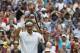 Roger Federer of Switzerland celebrates with the crowd after he defeated Stan Wawrinka of Switzerland in their men's singles quarterfinal match at the All England Lawn Tennis Championships in Wimbledon, London, Wednesday, July 2, 2014. (AP Photo/Pavel Golovkin)