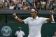 Roger Federer of Switzerland celebrates as he defeats Stan Wawrinka of Switzerland in their men's singles quarterfinal match at the All England Lawn Tennis Championships in Wimbledon, London, Wednesday, July 2, 2014. (AP Photo/Pavel Golovkin)