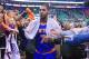 Fans reach for New York Knicks' Carmelo Anthony (7) as he walks off the court following their NBA basketball game against the Utah Jazz Monday, March 31, 2014, in Salt Lake City. The Knicks won 92-83. (AP Photo/Rick Bowmer)
