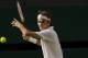 Jul 4, 2014; London, United Kingdom; Roger Federer (SUI) in action during his match against Milos Raonic (CAN) on day 11 of the 2014 Wimbledon Championships at the All England Lawn and Tennis Club. Mandatory Credit: Susan Mullane-USA TODAY Sports