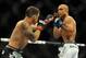 Jul 6, 2014; Las Vegas, NV, USA; BJ Penn (blue gloves) blocks a punch by Frankie Edgar (red gloves) during a featherweight fight at Mandalay Bay Events Center. Mandatory Credit: Stephen R. Sylvanie-USA TODAY Sports