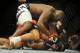 Jul 6, 2014; Las Vegas, NV, USA; Derrick Lewis (red gloves) takes down Guto Inocente (blue gloves) during a heavyweight fight at Mandalay Bay Events Center. Mandatory Credit: Stephen R. Sylvanie-USA TODAY Sports
