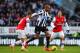 NEWCASTLE UPON TYNE, ENGLAND - DECEMBER 29: Loic Remy of Newcastle United is closed down by Jack Wilshere (L) and Tomas Rosicky of Arsenal during the Barclays Premier League match between Newcastle United and Arsenal at St James' Park on December 29, 2013 in Newcastle upon Tyne, England. (Photo by Michael Regan/Getty Images)