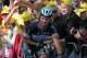 Mark Cavendish gingerly holds himself following his Stage One crash as British cycling fans watch on.