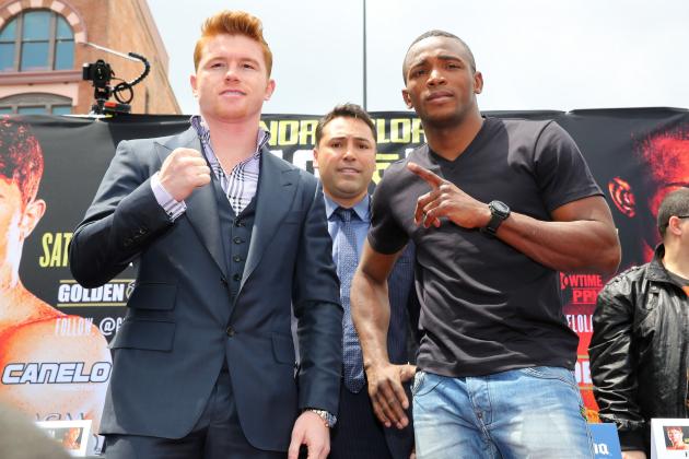 LOS ANGELES, CA - MAY 06:  Boxers Canelo Alvarez (L) and Erislandy Lara (R) and Oscar De La Hoya (C), president of Golden Boy Promotions, pose onstage during the press tour for Canelo Alvarez v Erislandy Lara on May 6, 2014 in Los Angeles, California.  (Photo by Victor Decolongon/Getty Images)