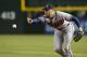 Atlanta Braves' Freddie Freeman tosses the ball to first base after fielding a ground ball hit by Arizona Diamondbacks' Didi Gregorius during the seventh inning of a baseball game on Saturday, June 7, 2014, in Phoenix. The Diamondbacks defeated the Braves 4-3. (AP Photo/Ross D. Franklin)