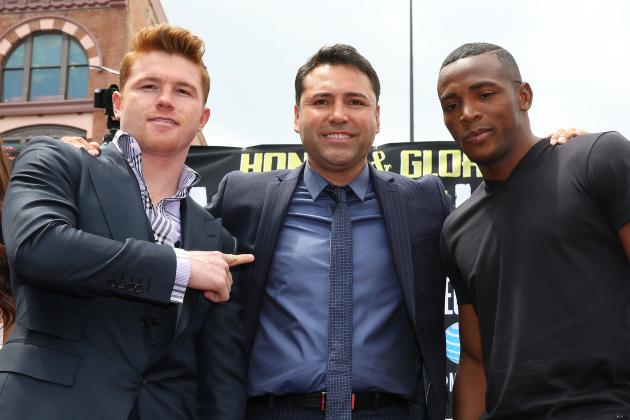 LOS ANGELES, CA - MAY 06:  Boxers Canelo Alvarez (L) and Erislandy Lara (R) and Oscar De La Hoya (C), president of Golden Boy Promotions, pose onstage during the press tour for Canelo Alvarez v Erislandy Lara on May 6, 2014 in Los Angeles, California.  (Photo by Victor Decolongon/Getty Images)