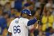 Los Angeles Dodgers' Yasiel Puig points toward first base after scoring on a single by Scott Van Slyke during the fourth inning of a baseball game against the San Diego Padres, Thursday, July 10, 2014, in Los Angeles. (AP Photo/Mark J. Terrill)