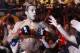 Defending featherweight champion Jose Aldo, from Brazil, celebrates with fans after defeating Chad Mendes, from the US, on the first round during their featherweight title bout at the Ultimate Fighting Championship (UFC) 142 in Rio de Janeiro, Brazil, Sunday Jan. 15, 2012. (AP Photo/Felipe Dana)