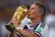 RIO DE JANEIRO, BRAZIL - JULY 13: Bastian Schweinsteiger of Germany kisses the World Cup trophy after defeating Argentina 1-0 in extra time during the 2014 FIFA World Cup Brazil Final match between Germany and Argentina at Maracana on July 13, 2014 in Rio de Janeiro, Brazil. (Photo by Clive Rose/Getty Images)