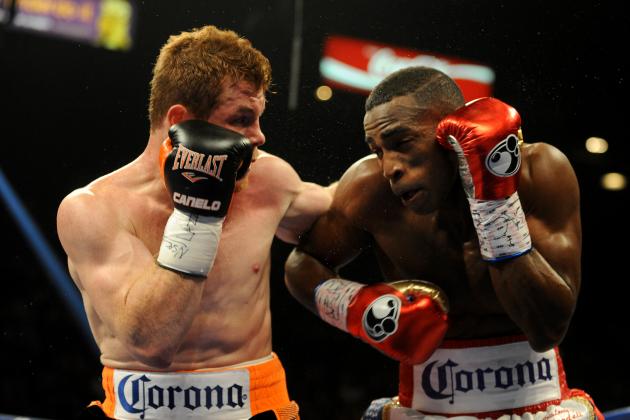 Jul 12, 2014; Las Vegas, NV, USA; Canelo Alvarez (black gloves) and Erislandy Lara (red gloves) exchange blows during a super welterweight fight at MGM Grand. Mandatory Credit: Stephen R. Sylvanie-USA TODAY Sports