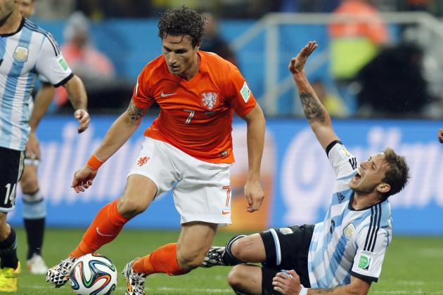 Argentina's Lucas Biglia, right, calls for medical treatment after colliding with Netherlands' Daryl Janmaat during the World Cup semifinal soccer match between the Netherlands and Argentina at the Itaquerao Stadium in Sao Paulo, Brazil, Wednesday, July 9, 2014. (AP Photo/Frank Augstein)