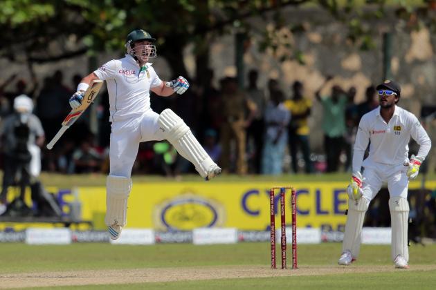 South African batsman Dean Elgar celebrates scoring a century as Sri Lanka wicketkeeper Dinesh Chandimal watches during the first day of the first test cricket match between Sri Lanka and South Africa in Galle, Sri Lanka, Wednesday, July 16, 2014. (AP Photo/Eranga Jayawardena)