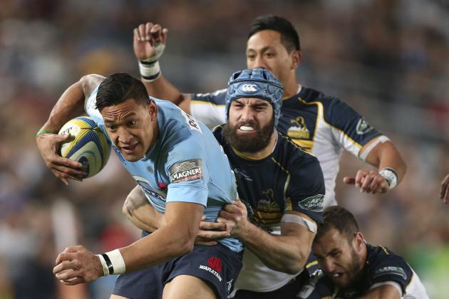 The Waratahs' Israel Folau left, is tackled by the Brumbies'  Scott Fardy center, Christian Lealiifano back, and Nic White during their Super Rugby Match in Sydney, Australia, Saturday, June 28, 2014.(AP Photo/Rob Griffith)