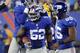 FILE - In this Nov. 17, 2013 file photo, New York Giants' Jon Beason (52) celebrates with teammates Jacquian Williams, left, and Keith Rivers (55) after Beason got an interception during the second half of an NFL football game against the Green Bay Packers, in East Rutherford, N.J. Beason has broken a bone in his right foot and is expected to miss most of training camp. The team announced Friday, June 13, 2014, that he also tore a ligament during Thursday's offseason training activity workout. (AP Photo/Bill Kostroun, File)