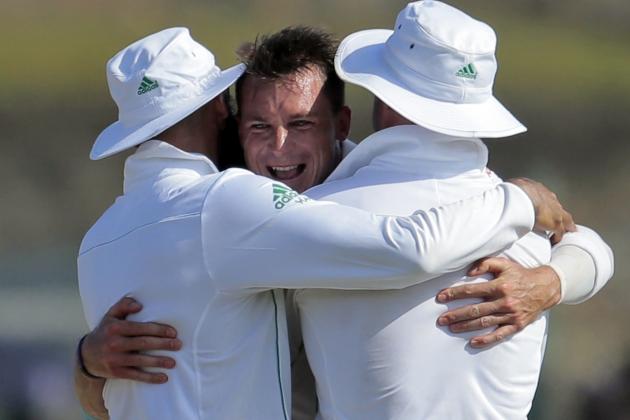 South African bowler Dale Steyn hugs captain Hashim Amla, left, and AB de Villiers as he celebrates the dismissal of Sri Lankan batsman Dinesh Chandimal during the third day of the first test cricket match between Sri Lanka and South Africa  in Galle, Sri Lanka, Friday, July 18, 2014. (AP Photo/Eranga Jayawardena)