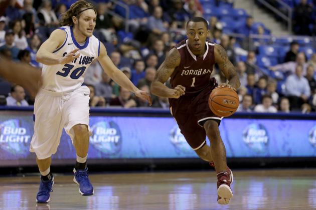 Fordham's Mandell Thomas, right, heads to the basket past Saint Louis' Jake Barnett during the first half of an NCAA college basketball game Saturday, Jan. 18, 2014, in St. Louis. (AP Photo/Jeff Roberson)