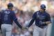 Tampa Bay Rays' Evan Longoria, right, rounds the bases and is congratulated by third base coach Tom Foley after his solo home run during the fourth inning of a baseball game against the Detroit Tigers in Detroit, Friday, July 4, 2014. (AP Photo/Carlos Osorio)