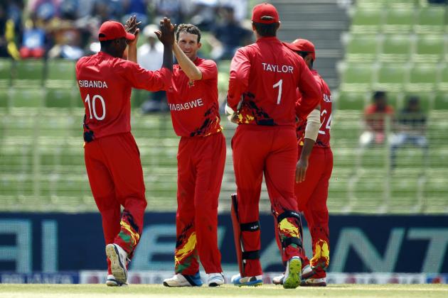 Zimbabwe's Sean Williams, second left, celebrates with his teammates the dismissal of United Arab Emirates' captain Khurram Khan during their ICC Twenty20 Cricket World Cup match in Sylhet, Bangladesh, Friday, March 21, 2014. (AP Photo/A.M. Ahad)