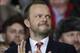 Manchester United chief executive Ed Woodward applauds before the team's English Premier League soccer match against Tottenham at Old Trafford Stadium, Manchester, England, Wednesday Jan. 1, 2014. (AP Photo/Jon Super)