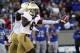 Notre Dame cornerback KeiVarae Russell, front, celebrates after recovering a fumble to stall a drive by Air Force in the second quarter of an NCAA college football game in Air Force Academy, Colo., Saturday, Oct. 26, 2013. (AP Photo/David Zalubowski)