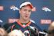Jun 10, 2014; Denver, CO, USA; Denver Broncos quarterback Peyton Manning (18) speaks to the media following mini camp drills at the Broncos practice facility. Mandatory Credit: Ron Chenoy-USA TODAY Sports