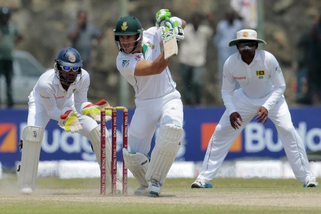 South African batsman Faf du Plessis, center, plays a shot as Sri Lankan wicketkeeper Dinesh Chandimal, left, and Mahela Jayawardene watch during the fourth day of the first test cricket mach between Sri Lanka and South Africa in Galle, Sri Lanka, Saturday, July 19, 2014. (AP Photo/Eranga Jayawardena)