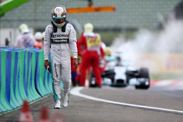 BUDAPEST, HUNGARY - JULY 26:  Lewis Hamilton of Great Britain and Mercedes GP walks away from his car after it caught fire during qualifying ahead of the Hungarian Formula One Grand Prix at Hungaroring on July 26, 2014 in Budapest, Hungary.  (Photo by Mark Thompson/Getty Images)