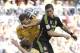 Spain's Fernando Torres goes for a header with Australia's Matthew Spiranovic during the group B World Cup soccer match between Australia and Spain at the Arena da Baixada in Curitiba, Brazil, Monday, June 23, 2014. (AP Photo/Fernando Vergara)